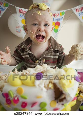 Picture - Baby covered in birthday cake. Fotosearch