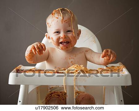 Stock Photograph - Baby covered in spaghetti. Fotosearch