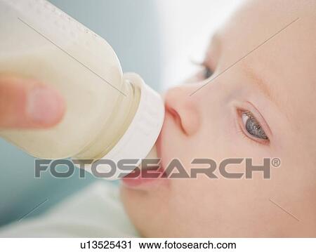 Baby drinking from bottle View Large Photo Image Stock Image - Baby drinking from bottle. Fotosearch