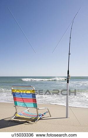 Beach chair and fishing rod View Large Photo Image Stock Photograph - Beach chair and fishing rod. Fotosearch