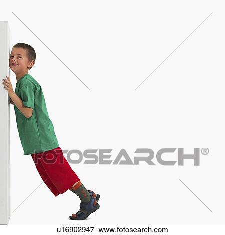 Stock Photo - Boy pushing something heavy. Fotosearch