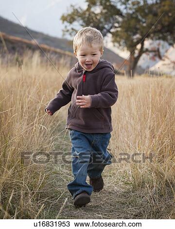 Boy running in meadow View Large Photo Image Stock Image - Boy running in meadow. Fotosearch