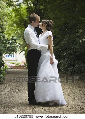 Stock Photography - Bride and groom kissing. Fotosearch