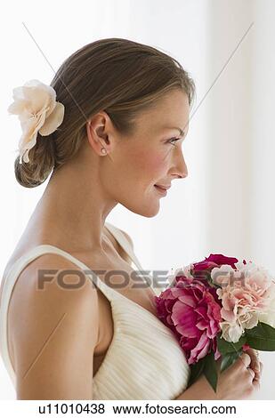 Bride holding bouquet of flowers View Large Photo Image Stock Photo - Bride holding bouquet of flowers. Fotosearch