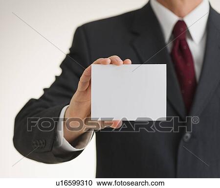 Businessman holding blank paper View Large Photo Image Stock Image - Businessman holding blank paper. Fotosearch
