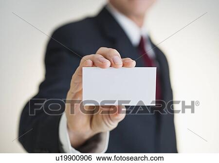 Businessman holding white card View Large Photo Image Stock Photograph - Businessman holding white card. Fotosearch