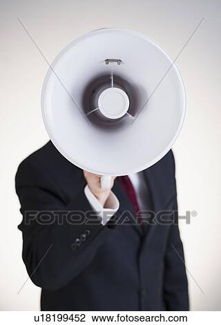 Stock Image - Businessman speaking into bullhorn. Fotosearch
