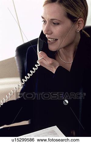 Stock Photograph - Businesswoman talking on phone. Fotosearch