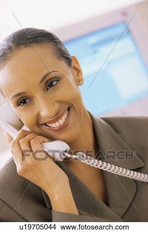 Picture - Businesswoman talking on the phone. Fotosearch