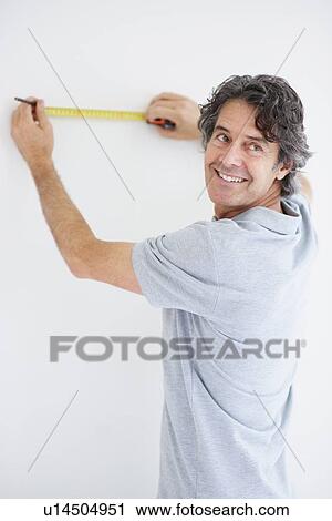 Carpenter marking straight line on wall View Large Photo Image Stock Image - Carpenter marking straight line on wall. Fotosearch