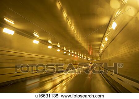 Cars driving in a tunnel View Large Photo Image Stock Photography - Cars driving in a tunnel. Fotosearch