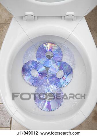 Stock Image - CD's in a toilet bowl. Fotosearch