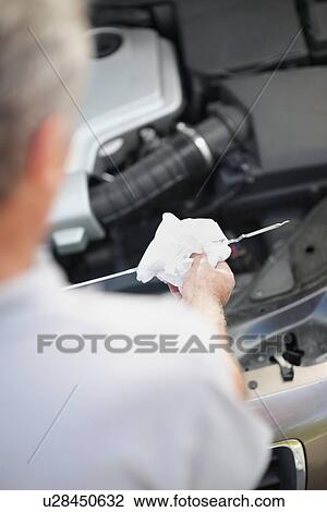 Stock Image - Checking the oil. Fotosearch