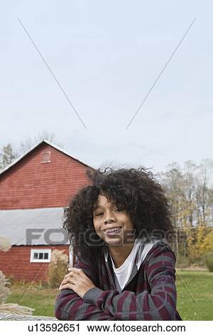 Stock Image - Child leaning on fence. Fotosearch