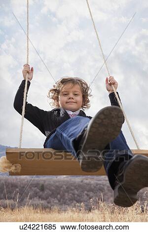 Stock Photography - Child on swing. Fotosearch