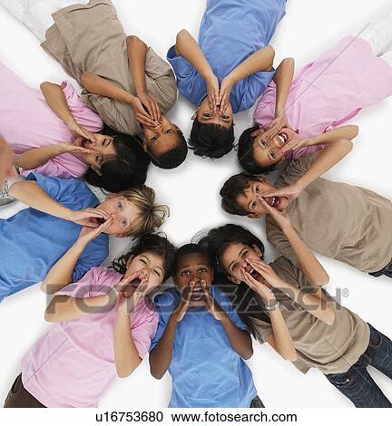 Stock Image - Children lying in a circle. Fotosearch