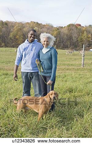 Stock Photograph - Couple and their dog. Fotosearch