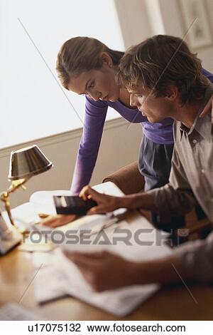 Stock Image - Couple doing finances. Fotosearch