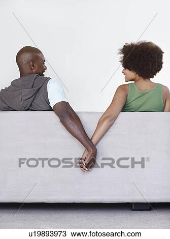 Stock Image - Couple holding hands. Fotosearch