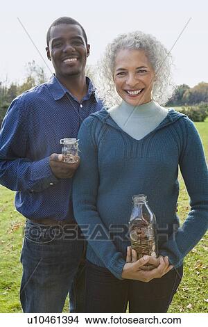 Picture - Couple holding jars. Fotosearch