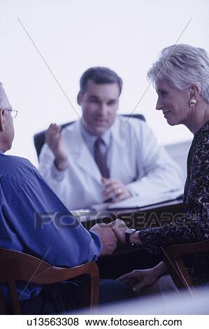 Stock Photo - Couple in doctor's office. Fotosearch