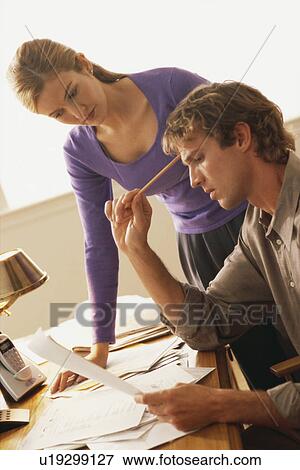 Couple looking at bills View Large Photo Image Stock Photo - Couple looking at bills. Fotosearch