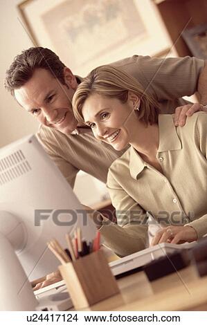 Picture - Couple looking at computer. Fotosearch