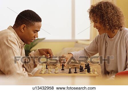 Stock Photo - Couple playing chess. Fotosearch