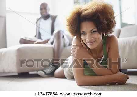 Picture - Couple relaxing in living room. Fotosearch