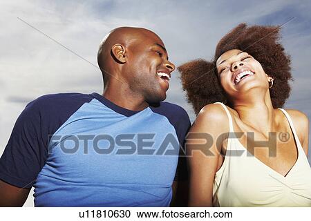 Stock Image - Couple relaxing outside. Fotosearch
