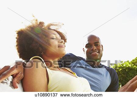 Couple relaxing outside View Large Photo Image Stock Photo - Couple relaxing outside. Fotosearch