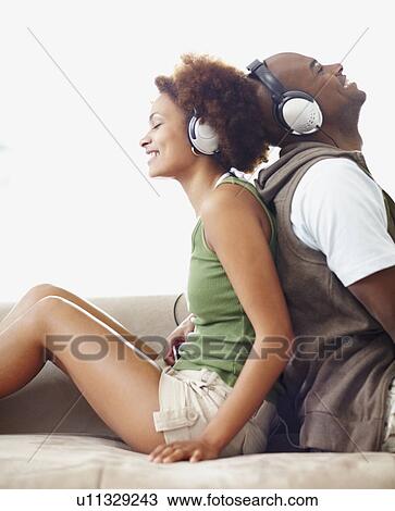 Stock Image - Couple wearing headphones. Fotosearch