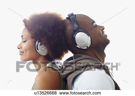 Couple wearing headphones View Large Photo Image Stock Photo - Couple wearing headphones. Fotosearch