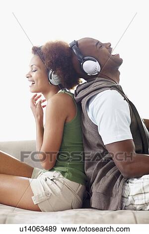 Stock Photo - Couple wearing headphones. Fotosearch