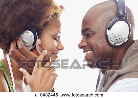Stock Photography - Couple wearing headphones. Fotosearch
