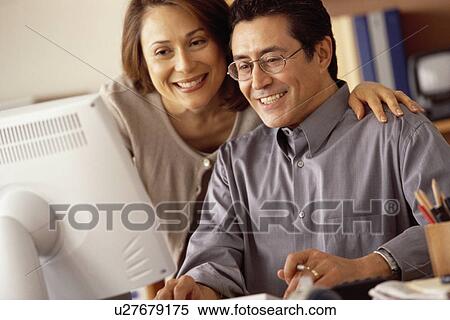 Couple working at computer in home office View Large Photo Image Stock Photography - Couple working at computer in home office. Fotosearch