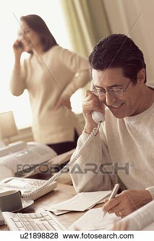 Stock Photo - Couple working in home office. Fotosearch
