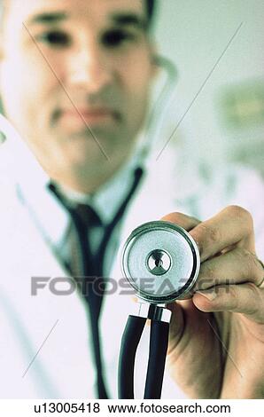 Doctor holding a stethoscope View Large Photo Image Stock Photo - Doctor holding a stethoscope. Fotosearch