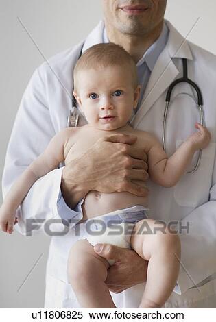 Stock Photography - Doctor holding baby. Fotosearch