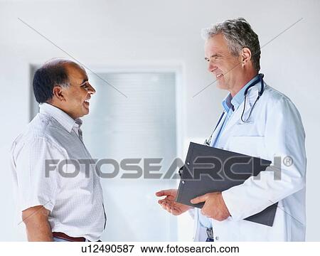 Doctor talking to patient View Large Photo Image Stock Photo - Doctor talking to patient. Fotosearch