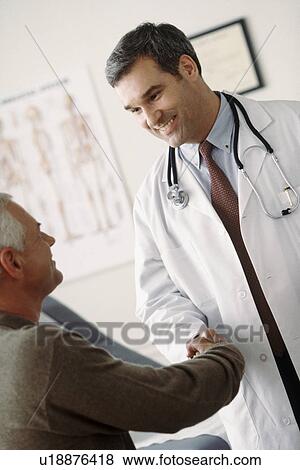 Stock Photo - Doctor talking to patient. Fotosearch