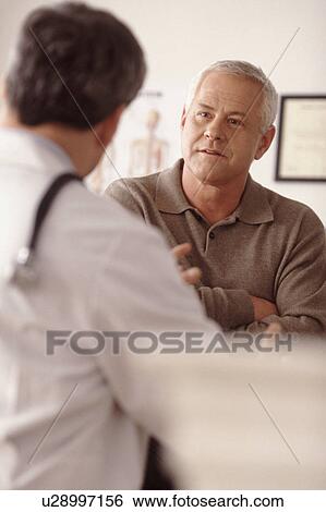 Stock Photograph - Doctor talking to patient. Fotosearch