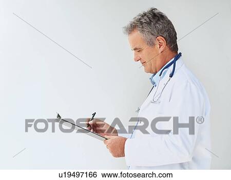 Stock Photograph - Doctor writing on clipboard. Fotosearch