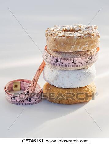 Donuts and measuring tape View Large Photo Image Stock Image - Donuts and measuring tape. Fotosearch