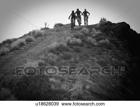 Stock Photo - Downhill mountain bikers. Fotosearch