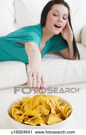 Stock Image - Eating tortilla chips. Fotosearch