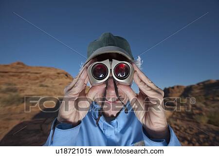 Stock Photography - Elderly woman looking through binoculars. Fotosearch