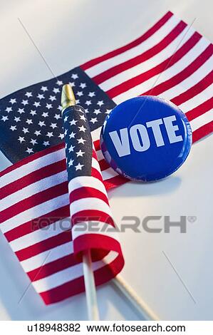 Stock Image - Election pin and American flags. Fotosearch