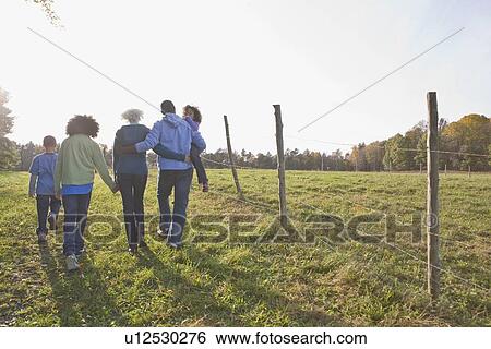 Family going for a walk View Large Photo Image Stock Photograph - Family going for a walk. Fotosearch