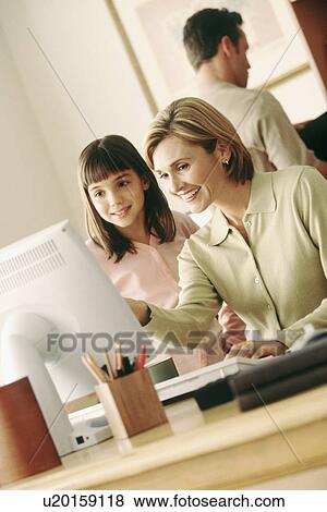 Family in home office View Large Photo Image Stock Photo - Family in home office. Fotosearch